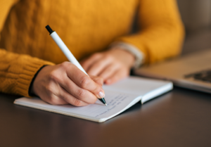 Person writing in notebook taking a CanNRT workshop.